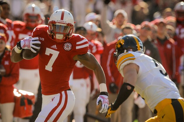LINCOLN, NE - NOVEMBER 29: Wide receiver Taariq Allen #7 of the Nebraska Cornhuskers runs past the Iowa Hawkeyes during their game at Memorial stadium on November 29, 2013 in Lincoln, Nebraska. (Photo by Eric Francis/Getty Images)