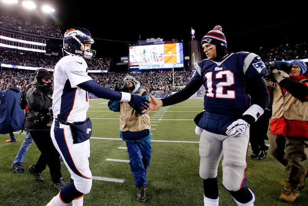 FOXBORO, MA - NOVEMBER 24: Quarterback Peyton Manning #18 of the Denver Broncos and quarterback Tom Brady #12 of the New England Patriots shake hands after the New England Patriots defeated the Denver Broncos 34-31 in overtime at Gillette Stadium on November 24, 2013 in Foxboro, Massachusetts.  (Photo by Jim Rogash/Getty Images)