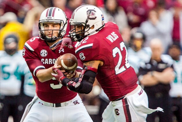 Nov 23, 2013; Columbia, SC, USA; South Carolina Gamecocks quarterback Brendan Nosovitch (5) hands off to running back Brandon Wilds (22) in the second half at Williams-Brice Stadium. Mandatory Credit: Jeff Blake-USA TODAY
