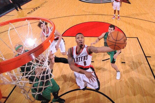 PORTLAND, OR - JANUARY 11:  Damian Lillard #0 of the Portland Trail Blazers drives to the basket against the Boston Celtics on January 11, 2014 at the Moda Center Arena in Portland, Oregon. NOTE TO USER: User expressly acknowledges and agrees that, by downloading and or using this photograph, user is consenting to the terms and conditions of the Getty Images License Agreement. Mandatory Copyright Notice: Copyright 2014 NBAE (Photo by Sam Forencich/NBAE via Getty Images)