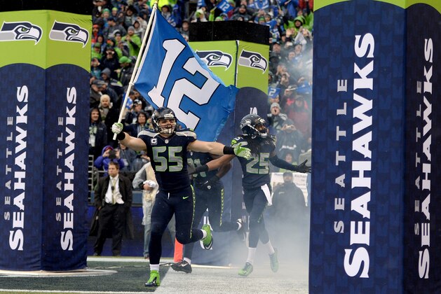SEATTLE, WA - JANUARY 11: Linebacker Heath Farwell #55 of the Seattle Seahawks runs out of the tunnel with the 12th Man flag before taking on the New Orleans Saints during the NFC Divisional Playoff Game at CenturyLink Field on January 11, 2014 in Seattle, Washington. (Photo by Harry How/Getty Images) SEATTLE, WA - JANUARY 11: Linebacker Heath Farwell #55 of the Seattle Seahawks runs out of the tunnel with the 12th Man flag before taking on the New Orleans Saints during the NFC Divisional Playoff Game at CenturyLink Field on January 11, 2014 in Seattle, Washington. (Photo by Harry How/Getty Images)