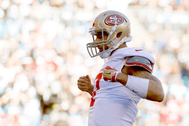 CHARLOTTE, NC - JANUARY 12:  Colin Kaepernick #7 of the San Francisco 49ers celebrates after a touchdown in the third quarter against the Carolina Panthers during the NFC Divisional Playoff Game at Bank of America Stadium on January 12, 2014 in Charlotte, North Carolina.  (Photo by Kevin C. Cox/Getty Images)