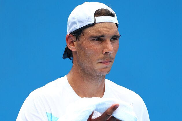MELBOURNE, AUSTRALIA - JANUARY 15:  Rafael Nadal of Spain wipes his face with a towel during a practice session during day three of the 2014 Australian Open at Melbourne Park on January 15, 2014 in Melbourne, Australia.  (Photo by Robert Prezioso/Getty Images)