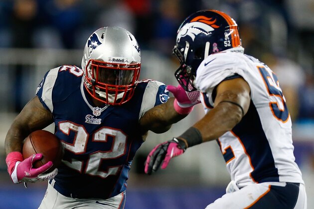 FOXBORO, MA - OCTOBER 07:  Stevan Ridley #22 of the New England Patriots runs with the ball around Wesley Woodyard #52 of the Denver Broncos in the second half during the game on October 7, 2012 at Gillette Stadium in Foxboro, Massachusetts.  (Photo by Jared Wickerham/Getty Images)