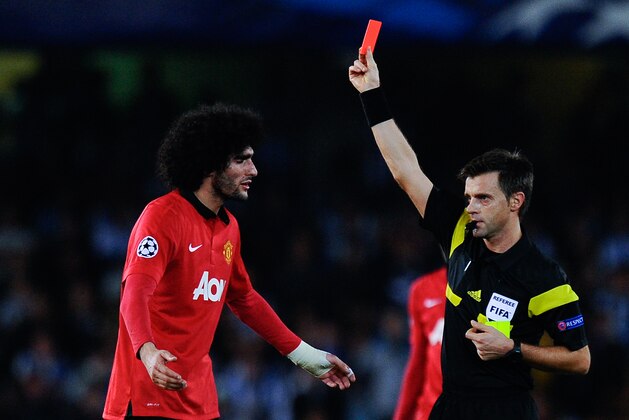 SAN SEBASTIAN, SPAIN - NOVEMBER 05:  Marouanne Fellaini of Manchester United is shown a red card by the referee Nicola Rizzoli for a challenge during the UEFA Champions League Group A match between Real Sociedad de Futbol and Manchester United at Estadio Anoeta on November 5, 2013 in San Sebastian, Spain.  (Photo by David Ramos/Getty Images)