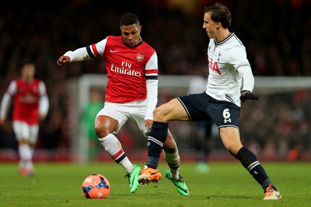 LONDON, ENGLAND - JANUARY 04:  Serge Gnabry of Arsenal and Vlad Chiriches of Spurs compete for the ball during the Budweiser FA Cup third round match between Arsenal and Tottenham Hotspur at Emirates Stadium on January 4, 2014 in London, England.  (Photo by Clive Rose/Getty Images)