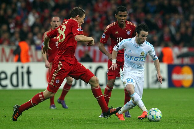 MUNICH, GERMANY - APRIL 03: Holger Badstuber (L) of Muenchen and Mathieu Valbuena (R) of Marseille battle for the ball during the UEFA Champions League quarter-final second leg match at Allianz Arena on April 3, 2012 in Munich, Germany.  (Photo by Martin Rose/Bongarts/Getty Images)