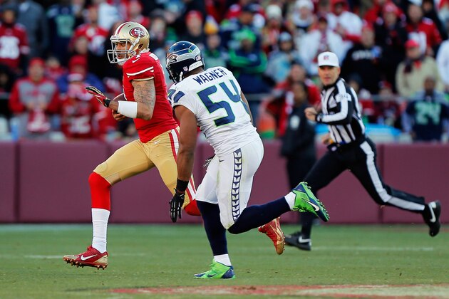 SAN FRANCISCO, CA - DECEMBER 08:  Quarterback Colin Kaepernick #7 of the San Francisco 49ers scrambles for six yards under pressure from linebacker Bobby Wagner #54 of the Seattle Seahawks in the third quarter on December 8, 2013 at Candlestick Park in San Francisco, California.  The 49ers won 19-17.  (Photo by Brian Bahr/Getty Images)