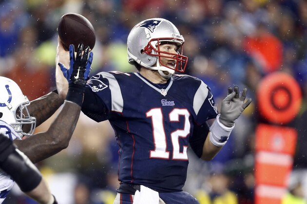 Jan 11, 2014; Foxborough, MA, USA; New England Patriots quarterback Tom Brady (12) throws a pass against the Indianapolis Colts in the second half during the 2013 AFC divisional playoff football game at Gillette Stadium. Mandatory Credit: Mark L. Baer-USA TODAY Sports