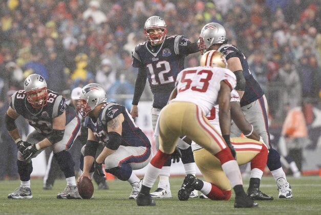 Dec 16, 2012; Foxborough, MA, USA; New England Patriots quarterback Tom Brady (12) at the line of scrimmage as they take on the San Francisco 49ers during the fourth quarter at Gillette Stadium. The San Francisco 49ers defeated the New England Patriots 41-34. Mandatory Credit: David Butler II-USA TODAY Sports
