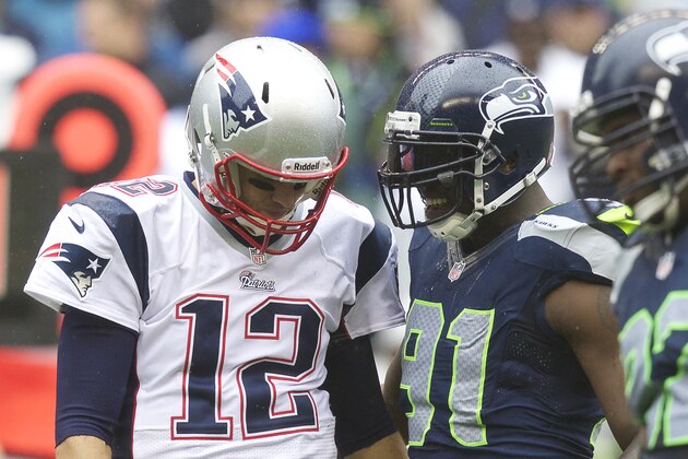 SEATTLE, WA - OCTOBER 14: Tom Brady #12 of the New England Patriots talks with Chris Clemons #91 of the Seattle Seahawks between plays during a game at CenturyLink Field on October 14, 2012 in Seattle, Washington. The Seahawks beat the Patriots 24-23.  (Photo by Stephen Brashear/Getty Images)