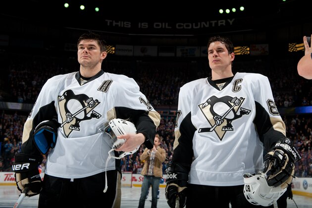 EDMONTON, AB - JANUARY 10: Chris Kunitz #14 and Sidney Crosby #87 of the Pittsburgh Penguins stand for the singing of the national anthem prior to a game against the Edmonton Oilers on January 10, 2014 at Rexall Place in Edmonton, Alberta, Canada. (Photo by Andy Devlin/NHLI via Getty Images)