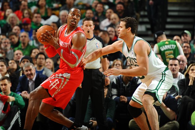 BOSTON, MA - JANUARY 13: Dwight Howard #12 of the Houston Rockets holds the ball against Kris Humphries #43 of the Boston Celtics on January 13, 2014 at the TD Garden in Boston, Massachusetts.  NOTE TO USER: User expressly acknowledges and agrees that, by downloading and or using this photograph, User is consenting to the terms and conditions of the Getty Images License Agreement. Mandatory Copyright Notice: Copyright 2014 NBAE  (Photo by Brian Babineau/NBAE via Getty Images)