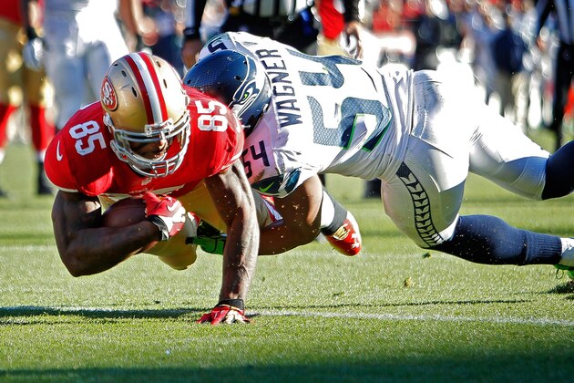 SAN FRANCISCO, CA - DECEMBER 08:  Tight end Vernon Davis #85 of the San Francisco 49ers scores a touchdown against linebacker Bobby Wagner #54 of the Seattle Seahawks in the second quarter on December 8, 2013 at Candlestick Park in San Francisco, California.  The 49ers won 19-17.  (Photo by Brian Bahr/Getty Images)