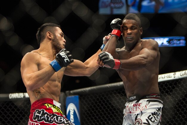 Jan 15, 2014; Duluth, GA, USA; Lorenz Larkin (red gloves) fights Brad Tavares (blue gloves) during UFC Fight Night at Gwinnett Center. Mandatory Credit: Joshua S. Kelly-USA TODAY Sports