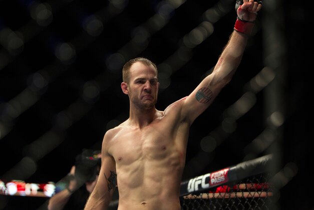 Jan 15, 2014; Duluth, GA, USA;  Cole Miller (red gloves) reacts during his fight with Sam Sicilia (not pictured) during UFC Fight Night at Gwinnett Center. Miller won. Mandatory Credit: Joshua S. Kelly-USA TODAY Sports