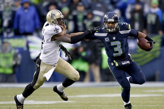 SEATTLE, WA - JANUARY 11: Quarterback Russell Wilson #3 of the Seattle Seahawks pushes back strong safety Roman Harper #41 of the New Orleans Saints in the fourth quarter while taking on the New Orleans Saints during the NFC Divisional Playoff Game at CenturyLink Field on January 11, 2014 in Seattle, Washington. (Photo by Otto Greule Jr/Getty Images) SEATTLE, WA - JANUARY 11: Quarterback Russell Wilson #3 of the Seattle Seahawks pushes back strong safety Roman Harper #41 of the New Orleans Saints in the fourth quarter while taking on the New Orleans Saints during the NFC Divisional Playoff Game at CenturyLink Field on January 11, 2014 in Seattle, Washington. (Photo by Otto Greule Jr/Getty Images)
