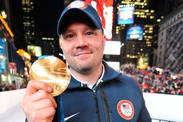 NEW YORK, NY - OCTOBER 29:  Bobsledder Steve Holcomb poses with his medal during the USOC 100 Days Out 2014 Sochi Winter Olympics Celebration at Times Square on October 29, 2013 in New York City.  (Photo by D Dipasupil/Getty Images for USOC)