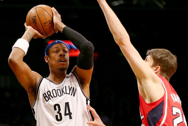 BROOKLYN, NY - JANUARY 06:  Paul Pierce #34 of the Brooklyn Nets looks to pass as Kyle Korver #26 of the Atlanta Hawks defends at the Barclays Center on January 6, 2014 in the Brooklyn borough of New York City.The Brooklyn Nets defeated the Atlanta Hawks 91-86. NOTE TO USER: User expressly acknowledges and agrees that, by downloading and/or using this photograph, user is consenting to the terms and conditions of the Getty Images License Agreement.  (Photo by Elsa/Getty Images)