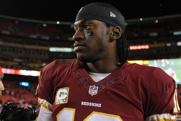 Nov 25, 2013; Landover, MD, USA; Washington Redskins quarterback Robert Griffin III (10) walks off the field after the game against the San Francisco 49ers at FedEx Field. The 49ers won 27-6. Mandatory Credit: Geoff Burke-USA TODAY Sports