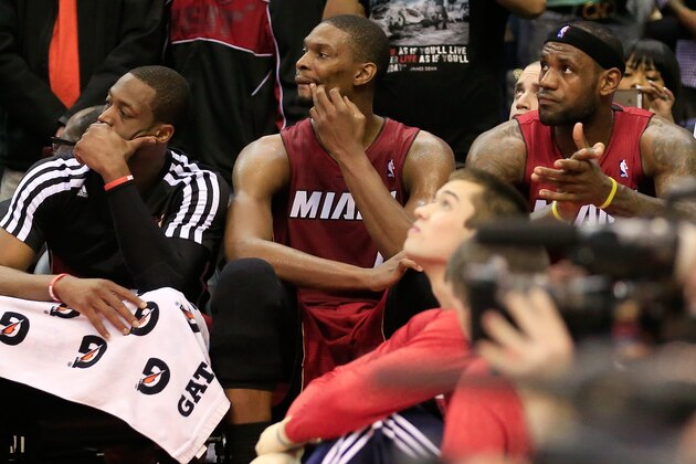 WASHINGTON, DC - JANUARY 15: Dwyane Wade #3 (L), Chris Bosh #1 (C), and LeBron James #6 of the Miami Heat sit on the bench during the closing moments of the Heat's 114-97 loss to the Washington Wizards at Verizon Center on January 15, 2014 in Washington, DC. NOTE TO USER: User expressly acknowledges and agrees that, by downloading and or using this photograph, User is consenting to the terms and conditions of the Getty Images License Agreement.  (Photo by Rob Carr/Getty Images)