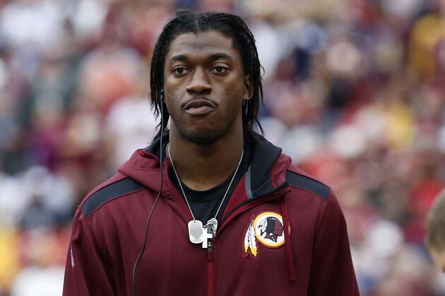 Dec 22, 2013; Landover, MD, USA; Washington Redskins quarterback Robert Griffin III stands on the sidelines against the Dallas Cowboys in the second quarter at FedEx Field. Mandatory Credit: Geoff Burke-USA TODAY Sports