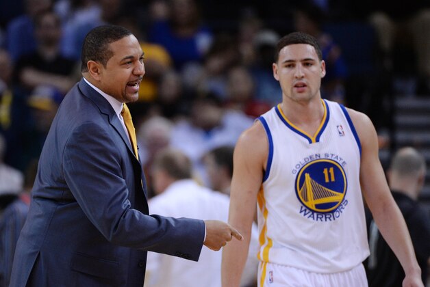 January 15, 2014; Oakland, CA, USA; Golden State Warriors head coach Mark Jackson (left) instructs in front of shooting guard Klay Thompson (11) against the Denver Nuggets during the first quarter at Oracle Arena. Mandatory Credit: Kyle Terada-USA TODAY Sports