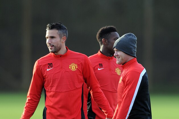 MANCHESTER, ENGLAND - DECEMBER 09: Wayne Rooney of Manchester United looks on with team-mate Robin Van Persie  during a first team training session, ahead of their UEFA Champions League Group A match against Shakhtar Donetsk, at Aon Training Complex on December 09, 2013 in Manchester, England. (Photo by Chris Brunskill/Getty Images)