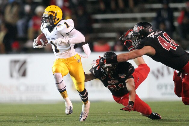 Jan 06, 2013; Mobile, AL USA; Kent State Golden Flashes running back Dri Archer (1) carries the ball past Arkansas State Red Wolves defensive end Timothy Starson (91) and linebacker Nathan Herrold (40)during the first half at Ladd-Peebles Stadium. Mandatory Credit: Crystal LoGiudice-USA TODAY Sports