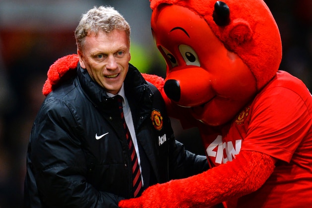MANCHESTER, ENGLAND - JANUARY 11:  Manchester United Manager David Moyes is greeted by mascot Fred the Red prior to the Barclays Premier League match between Manchester United and Swansea City at Old Trafford on January 11, 2014 in Manchester, England.  (Photo by Shaun Botterill/Getty Images)