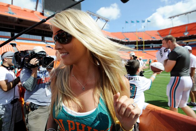 Aug. 4, 2012;  Miami, FL, USA; Lauren Ufer (left) the wife of Miami Dolphins quarterback Ryan Tannehill (right) leaves field after a teams scrimmage at Sun Life Stadium. Mandatory Credit: Steve Mitchell-USA TODAY Sports