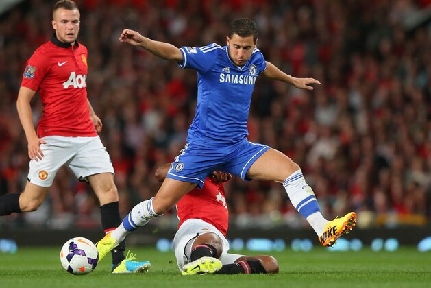 MANCHESTER, ENGLAND - AUGUST 26:  Eden Hazard of Chelsea is challenged by Antonio Valencia of Manchester United  during the Barclays Premier League match between Manchester United and Chelsea at Old Trafford on August 26, 2013 in Manchester, England.  (Photo by Alex Livesey/Getty Images)