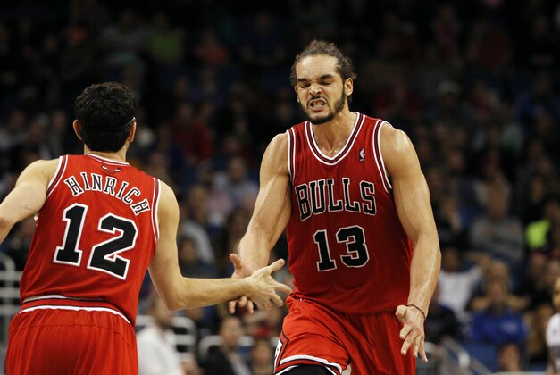 Jan 15, 2014; Orlando, FL, USA; Chicago Bulls center Joakim Noah (13) and shooting guard Kirk Hinrich (12) high five and reacts during double overtime against the Orlando Magic  at Amway Center. Chicago Bulls defeated the Orlando Magic 128-125 in triple overtime. Mandatory Credit: Kim Klement-USA TODAY Sports