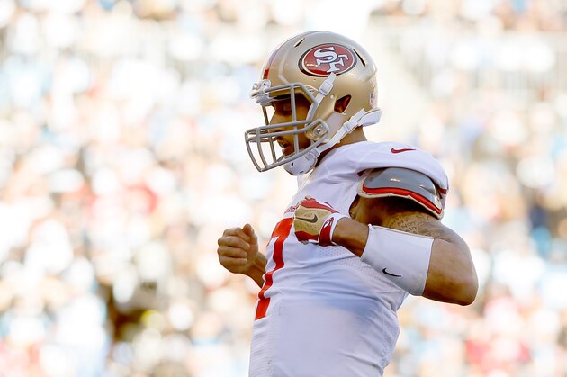 CHARLOTTE, NC - JANUARY 12:  Colin Kaepernick #7 of the San Francisco 49ers celebrates after a touchdown in the third quarter against the Carolina Panthers during the NFC Divisional Playoff Game at Bank of America Stadium on January 12, 2014 in Charlotte, North Carolina.  (Photo by Kevin C. Cox/Getty Images)