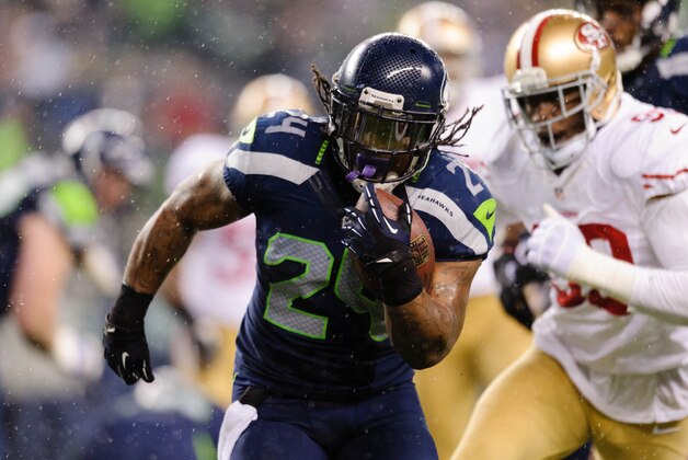 Dec 23, 2012; Seattle, WA, USA; Seattle Seahawks running back Marshawn Lynch (24) carries the ball against the San Francisco 49ers and later scores on the same play during the 1st half at CenturyLink Field. Mandatory Credit: Steven Bisig-USA TODAY Sports
