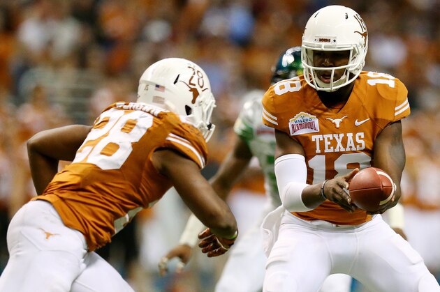 SAN ANTONIO, TX - DECEMBER 30: Quarterback Tyrone Swoopes #18 hands the ball off to running back Malcolm Brown #28 of the Texas Longhorns against the Oregon Ducks during the Valero Alamo Bowl at the Alamodome on December 30, 2013 in San Antonio, Texas.  (Photo by Ronald Martinez/Getty Images)