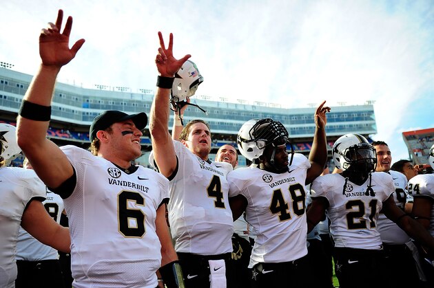 GAINESVILLE, FL - NOVEMBER 09:  Austin Carta-Samuels #6, Patton Robinette #4, Nigel Bowden #48 and Paris Head #21 of the Vanderbilt Commodores celebrate a victory over the Florida Gators following a game at Ben Hill Griffin Stadium on November 9, 2013 in Gainesville, Florida. Vanderbilt won the game 34-17.  (Photo by Stacy Revere/Getty Images)