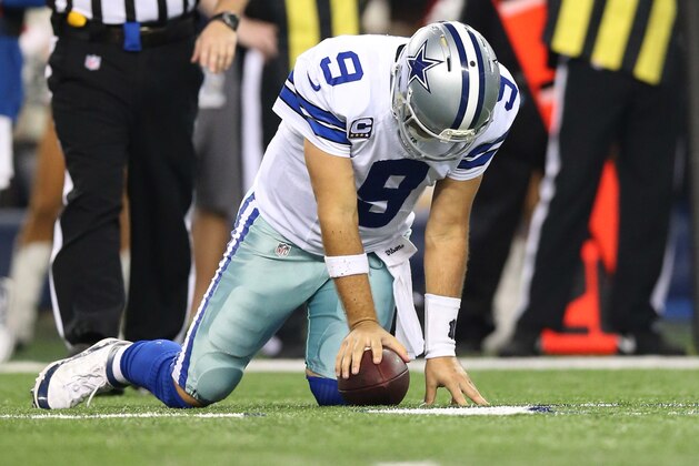 Dec 15, 2013; Arlington, TX, USA; Dallas Cowboys quarterback Tony Romo (9) reacts after getting sacked in the fourth quarter against the Green Bay Packers at AT&T Stadium. The Packers beat the Cowboys 37-36. Mandatory Credit: Matthew Emmons-USA TODAY Sports