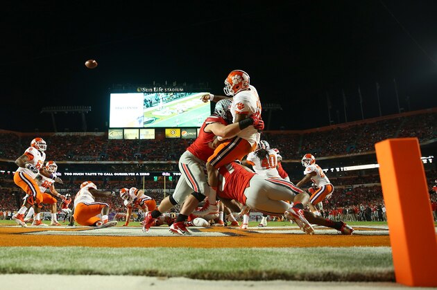MIAMI GARDENS, FL - JANUARY 03:  Tajh Boyd #10 of the Clemson Tigers throws the ball away and is called for intentional grounding resulting in a safety as Joey Bosa #97 and Joshua Perry #37 of the Ohio State Buckeyes defend in the first quarter during the Discover Orange Bowl at Sun Life Stadium on January 3, 2014 in Miami Gardens, Florida.  (Photo by Mike Ehrmann/Getty Images)