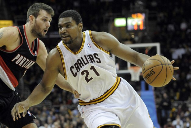 Dec 17, 2013; Cleveland, OH, USA; Cleveland Cavaliers center Andrew Bynum (21) drives against Portland Trail Blazers center Joel Freeland (19) in the fourth quarter at Quicken Loans Arena. Mandatory Credit: David Richard-USA TODAY Sports