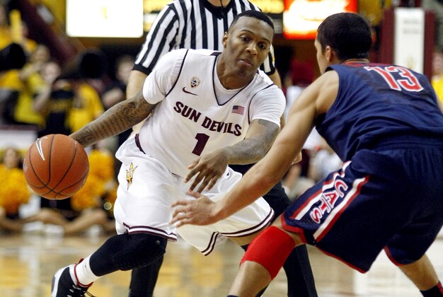 January 19, 2013; Tempe, AZ, USA; Arizona State Sun Devils guard Jahii Carson (1) drives on Arizona Wildcats guard Nick Johnson (13) during the second half at Wells Fargo Arena.  Mandatory Credit: Rick Scuteri-USA TODAY Sports