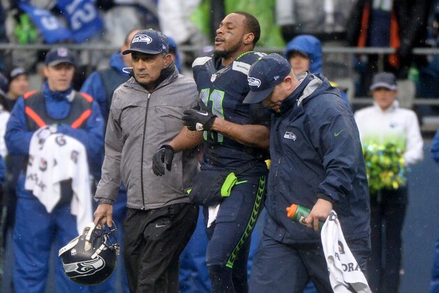 SEATTLE, WA - JANUARY 11:  Wide receiver Percy Harvin #11 of the Seattle Seahawks is helped off the field late in the second quarter against the New Orleans Saints during the NFC Divisional Playoff Game at CenturyLink Field on January 11, 2014 in Seattle, Washington.  (Photo by Harry How/Getty Images)