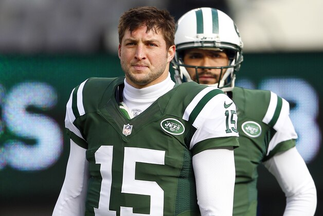 EAST RUTHERFORD, NJ - DECEMBER 23: Quarterbacks Tim Tebow #15 and Mark Sanchez #6, look on as teammate Greg McElroy #14 of the New York Jets passes before the start of their game against the San Diego Chargers at MetLife Stadium on December 23, 2012 in East Rutherford, New Jersey. (Photo by Rich Schultz/Getty Images)