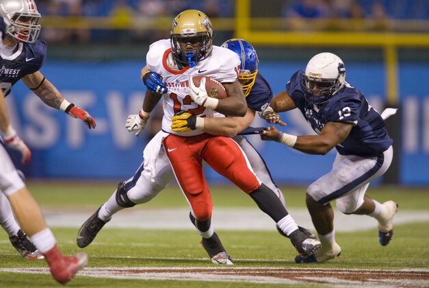 January 19, 2013; St. Petersburg, FL, USA; East running back Ray Graham of Pittsburgh runs the ball while defended by West linebacker Keith Pough of Howard in the East-West Shrine Game at Tropicana Field.  Mandatory Credit: Jeff Griffith-USA TODAY Sports