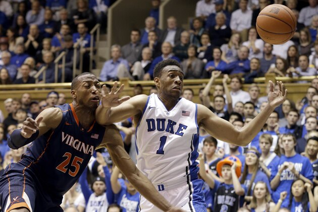 Duke's Jabari Parker (1) and Virginia's Akil Mitchell (25) reach for a rebound during the first half of an NCAA college basketball game in Durham, N.C., Monday, Jan. 13, 2014. (AP Photo/Gerry Broome)