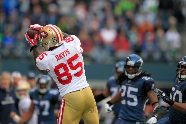 San Francisco 49ers'  Vernon Davis catches a pass against the Seattle Seahawks in the first half of an NFL football game in Seattle Saturday, Dec. 24, 2011. (AP Photo/John Froschauer)
