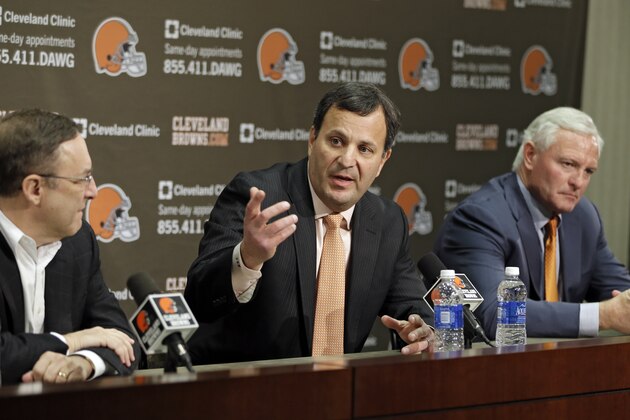 Mike Lombardi, center, the Cleveland Browns vice president of player personnel, answers questions at during an NFL football news conference with CEO Joe Banner, left, and owner Jimmy Haslam at the team's practice facility in Berea, Ohio, Friday, Jan. 18, 2013. (AP Photo/Mark Duncan)