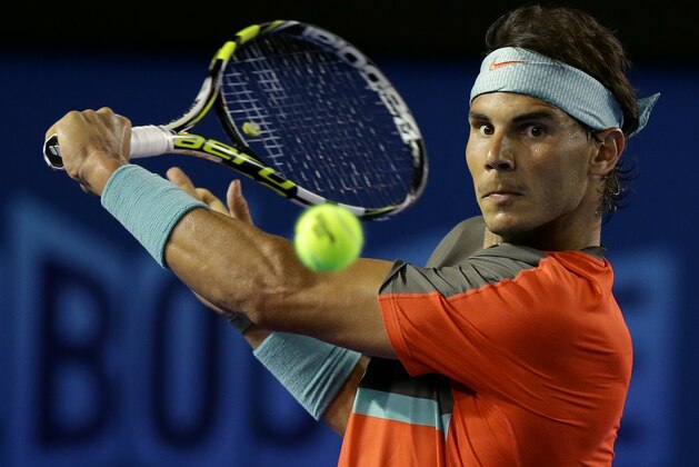 Rafael Nadal of Spain makes a backhand return to Thanasi Kokkinakis of Australia during their second round match at the Australian Open tennis championship in Melbourne, Australia, Thursday, Jan. 16, 2014.(AP Photo/Aaron Favila) Rafael Nadal of Spain makes a backhand return to Thanasi Kokkinakis of Australia during their second round match at the Australian Open tennis championship in Melbourne, Australia, Thursday, Jan. 16, 2014.(AP Photo/Aaron Favila)