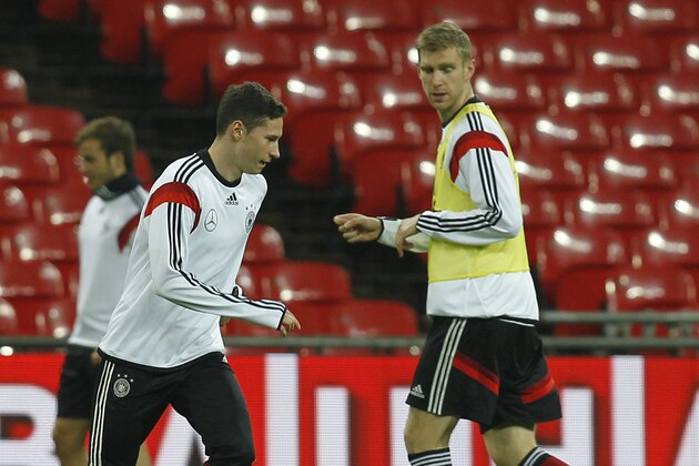 LONDON, ENGLAND - NOVEMBER 18: Julian Draxler and Per Mertesacker of Germany knock the ball about during a training session at Wembley Stadium ahead of their International Friendly against England on November 18, 2013 in London, England. (Photo by Charlie Crowhurst/Getty Images)