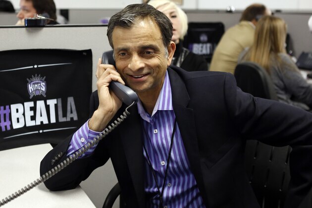 Vivek Ranadive, the new majority owner of the Sacramento Kings NBA basketball team smiles as a season ticket holder he called pledged to renew their seats, during a visit to the team's offices at Sleep Train Arena in Sacramento, Calif., Thursday, May 23, 2013. Ranadive joined employees in calling season ticket holders to encourage them to renew their tickets for next season. (AP Photo/Rich Pedroncelli)